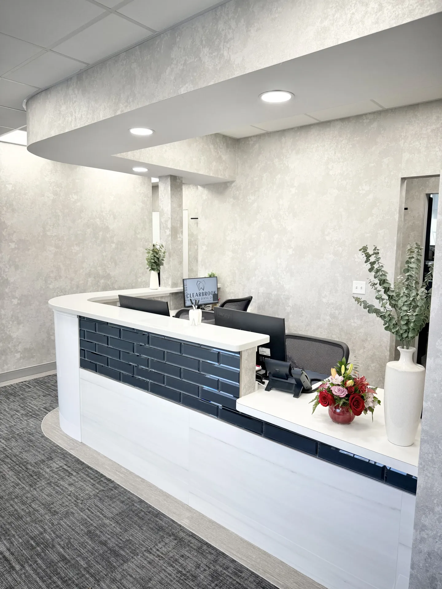 The branded reception desk with Clearbrook logo at Clearbrook Advanced Dental Care in Cranbury, NJ