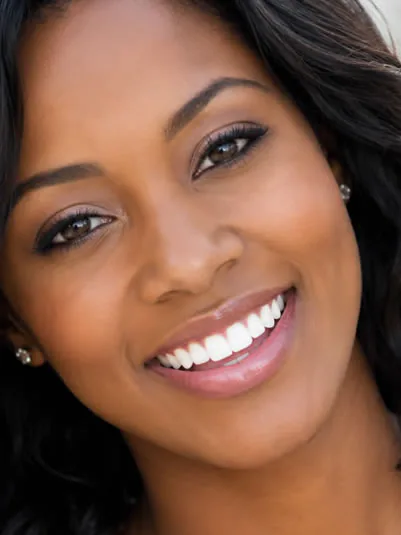 A woman with a bright, white smile after GLO teeth whitening at Clearbrook Advanced Dental Care in Cranbury, NJ